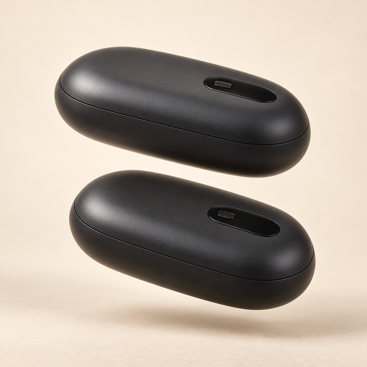 Two black ThermoSnap hand warmer halves side by side on a cream background